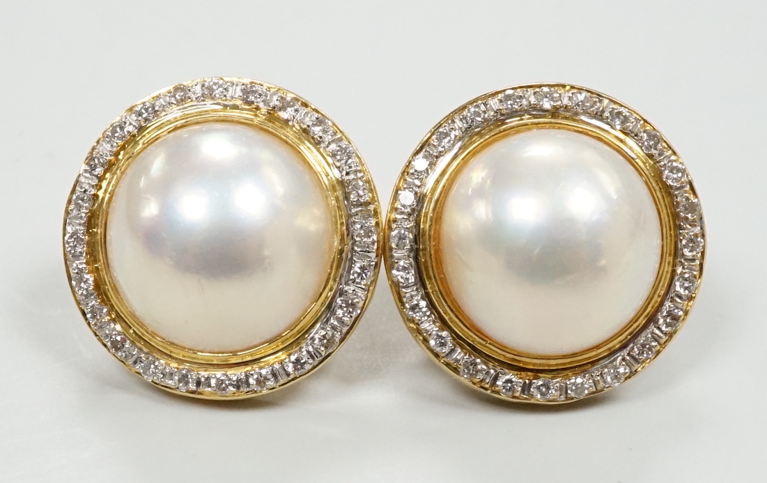 A pair of 750, mabe pearl and diamond cluster set circular earrings, diameter 18mm, gross weight 10.6 grams.
